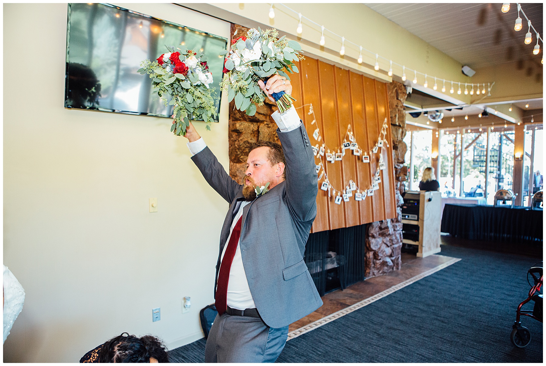 Groomsmand holding pumping flower into air