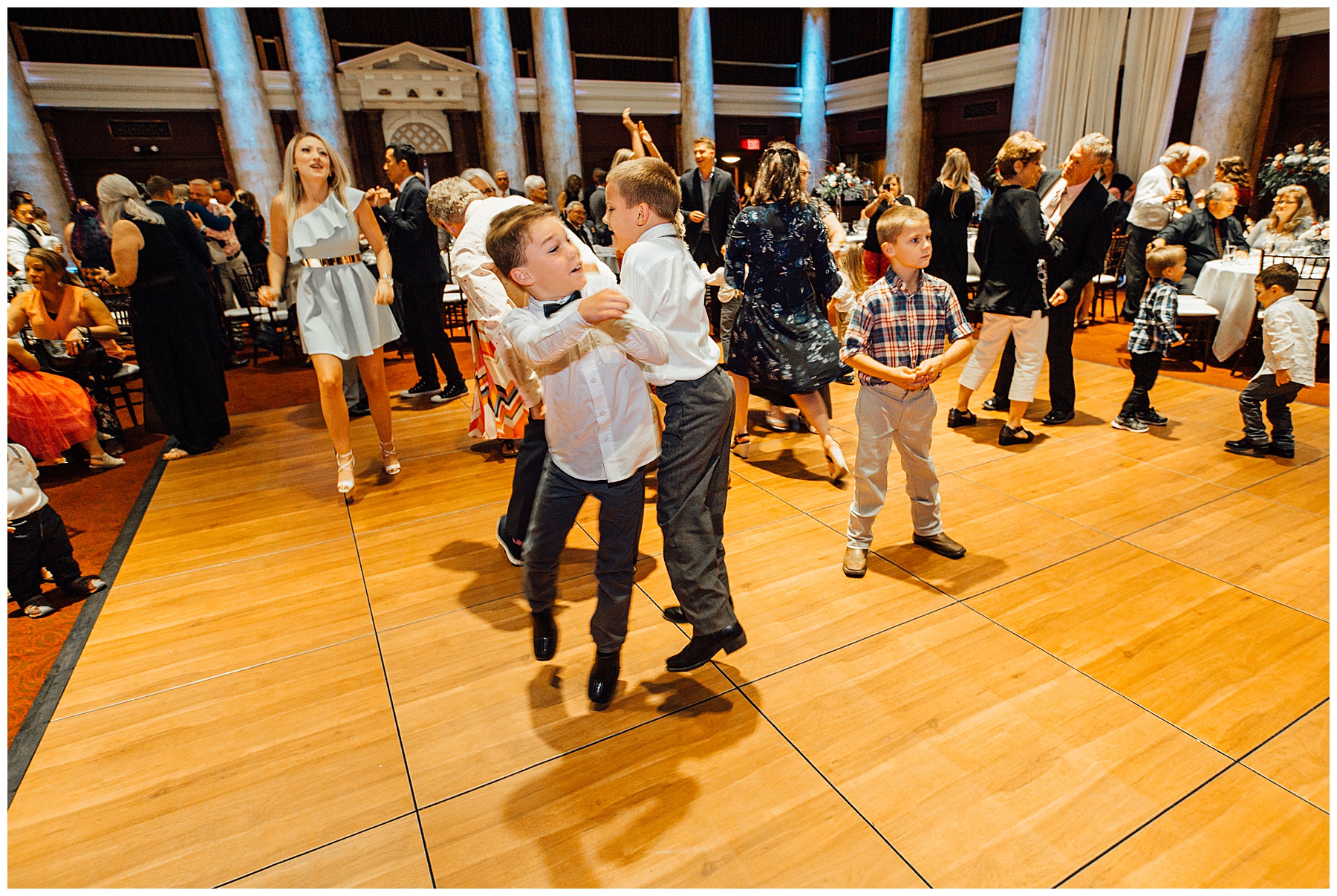 Groomsmen dancing on dance floor at The Temple for Performing Arts wedding photos