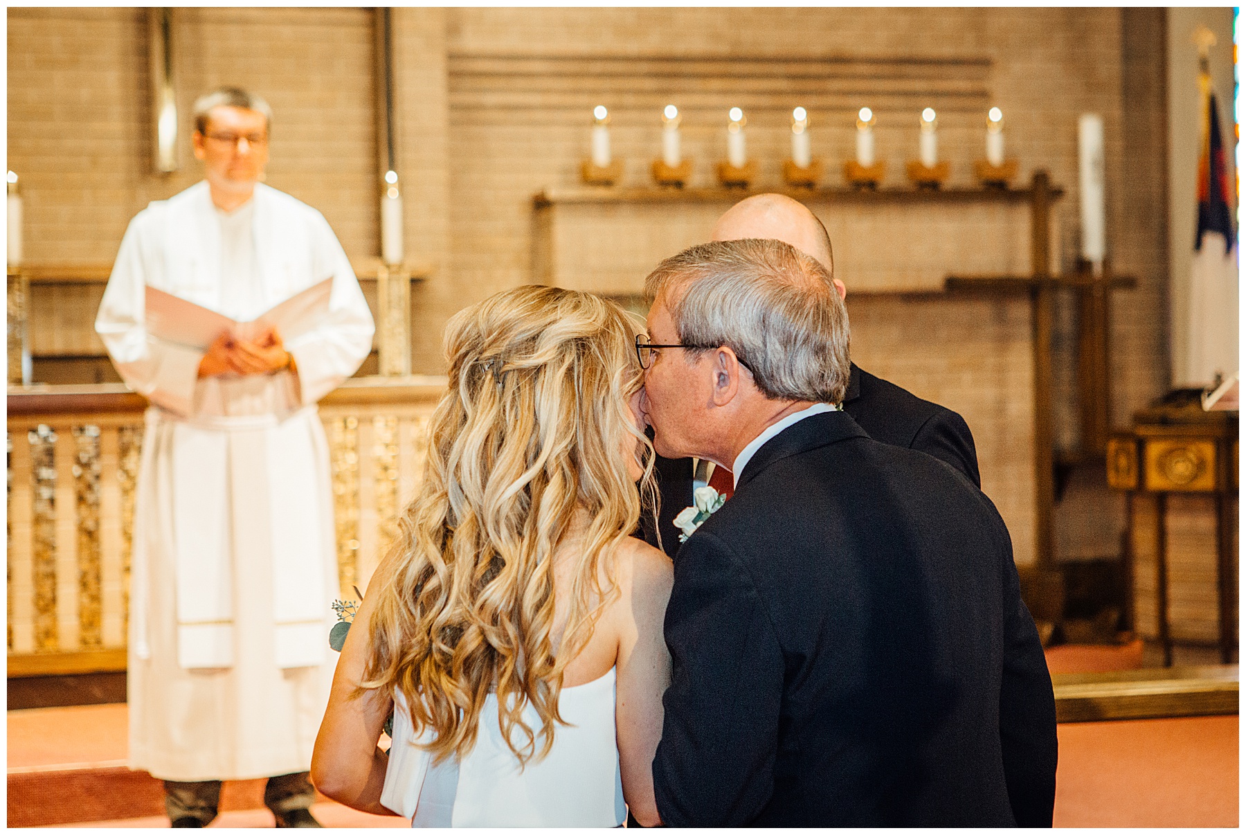 Father of the bride giving his daughter to the Groom at Lutheran Church of the Master Wedding