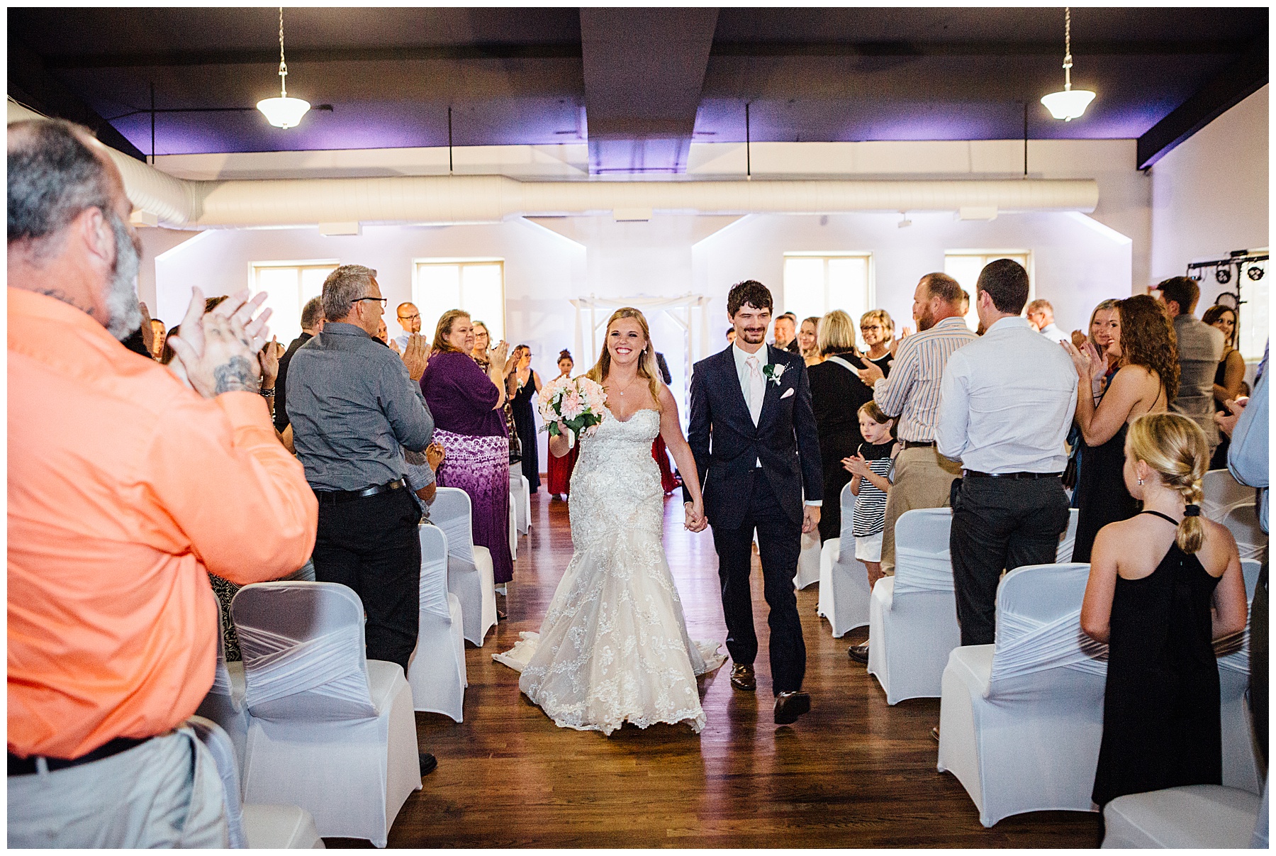 Bride and groom leaving ballroom