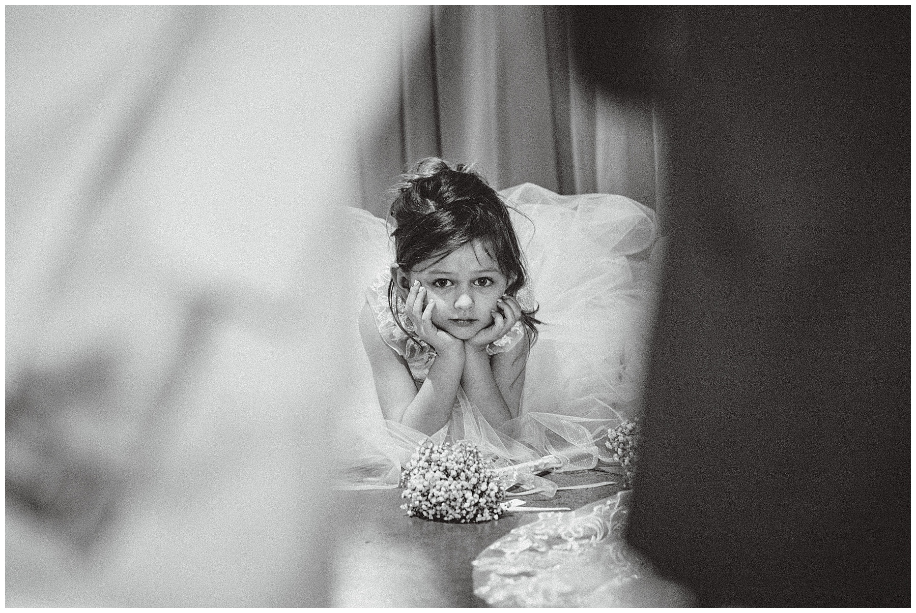 Flower girl hold hands on face during ceremony