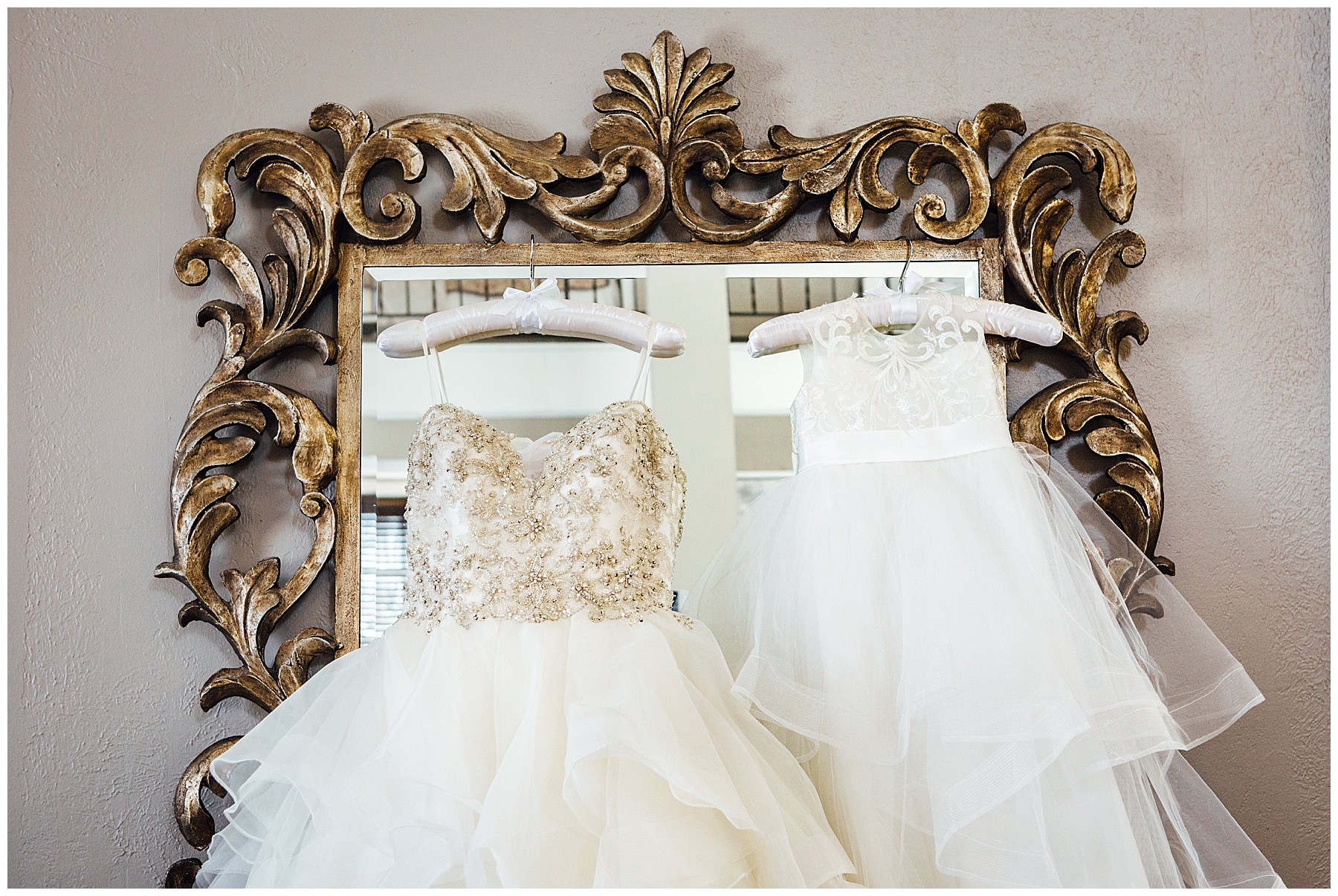 Wedding dresses hanging on mirror