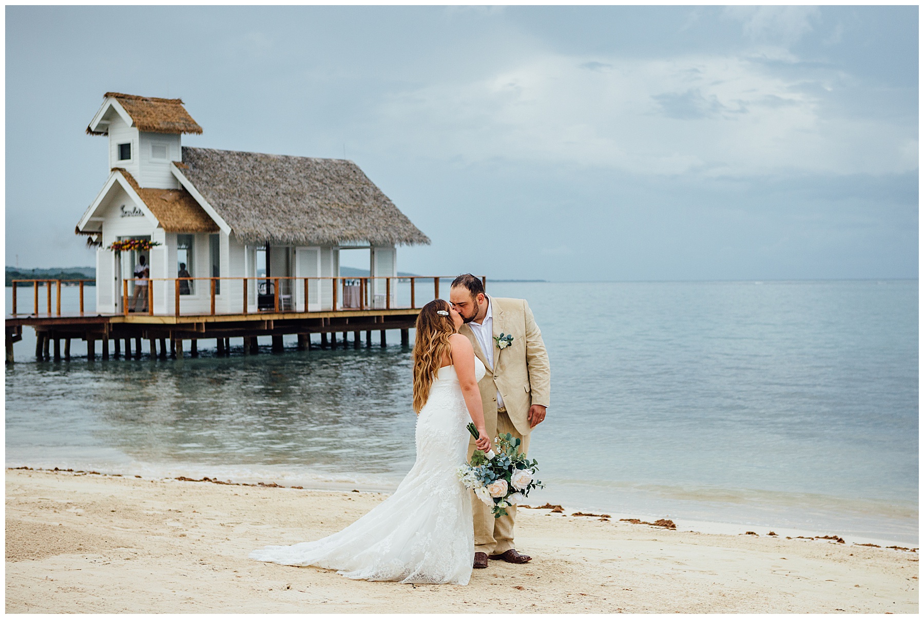 Bride and Groom kissing on beach in Jamaica
