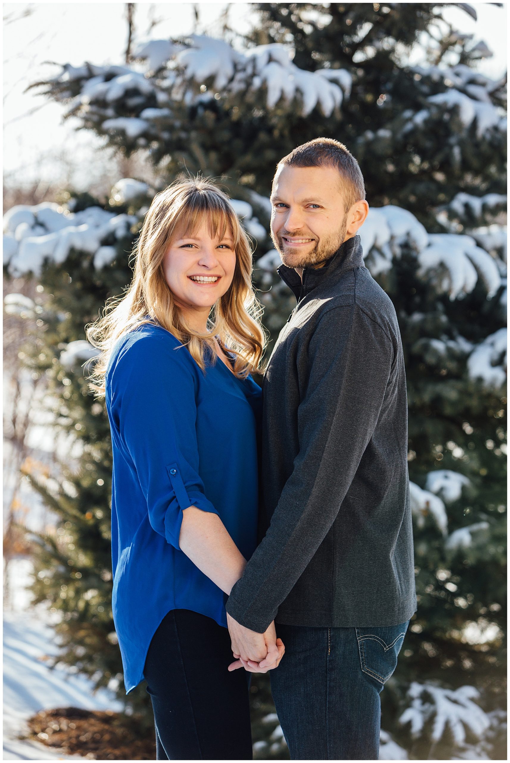 Engagement photos with snow on tree