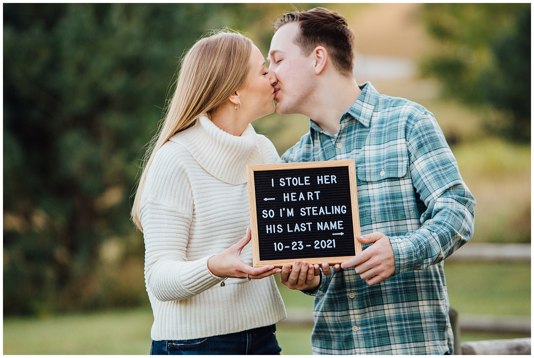 Engagement photo with sign